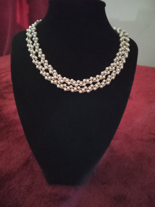 Tripled pearl beaded necklace accented in gold